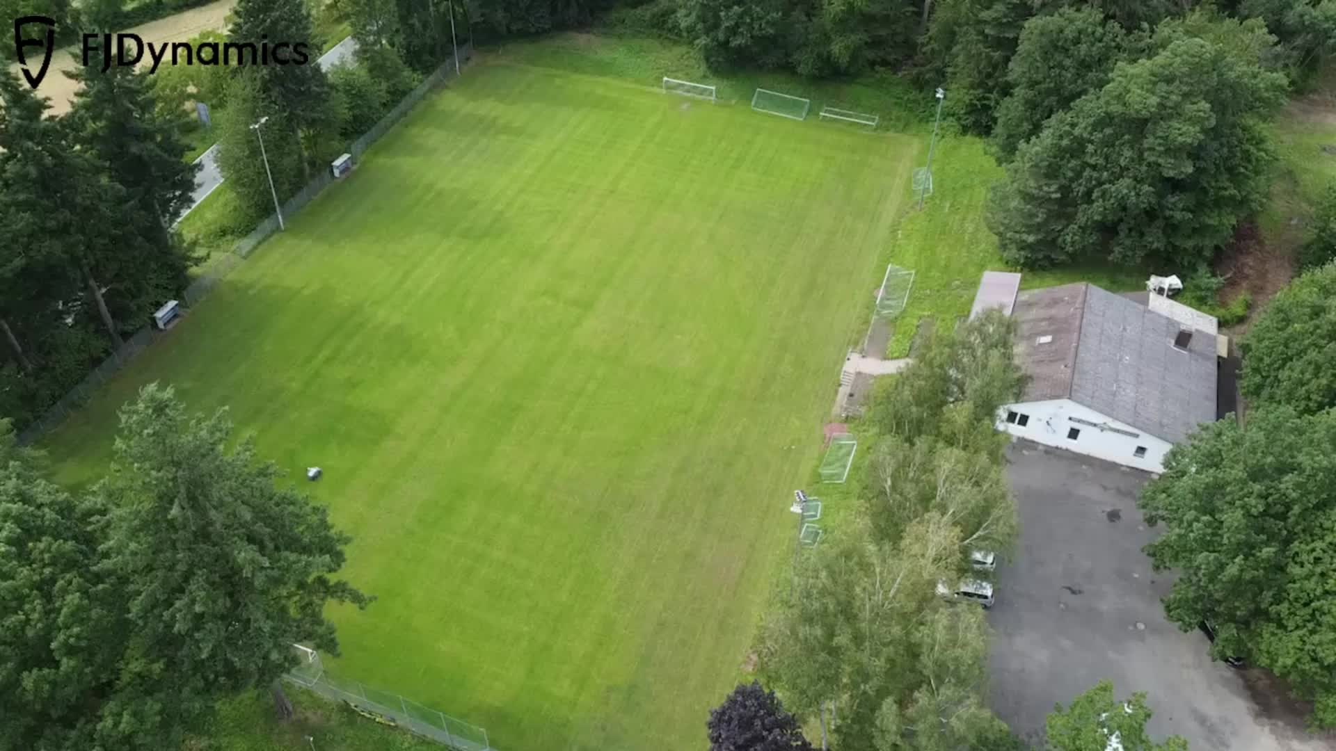 Lawn cutting and line marking for a football field in Germany