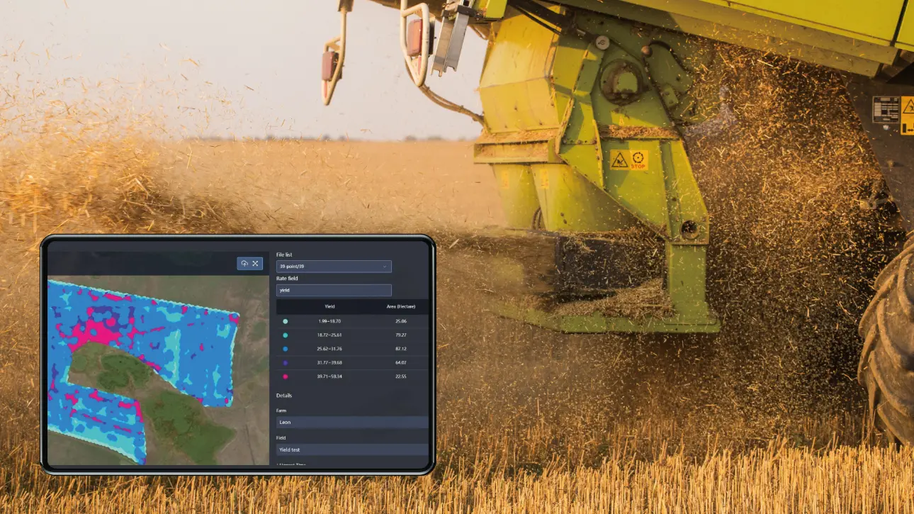 Combine harvesting while field performance data is reviewed on a connected display